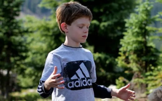 a boy with his hands out