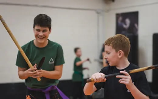 a few boys holding a sword