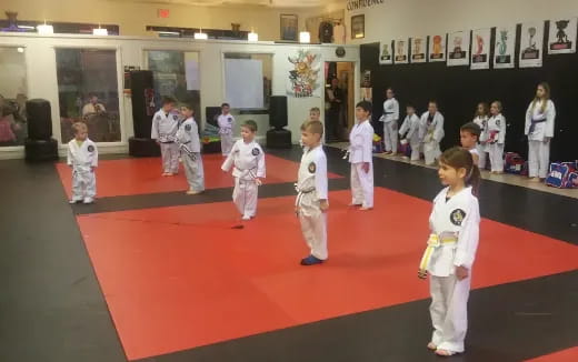 a group of children in white uniforms