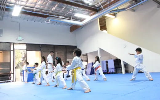 a group of people in karate uniforms