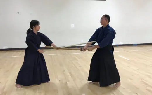 a man and woman holding a sword