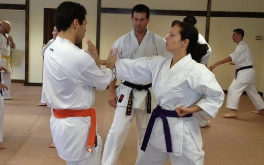 a group of people in karate uniforms