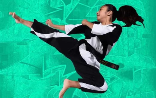 a man in a black and white outfit jumping in the air