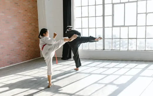 a man and a woman in karate uniforms in a room