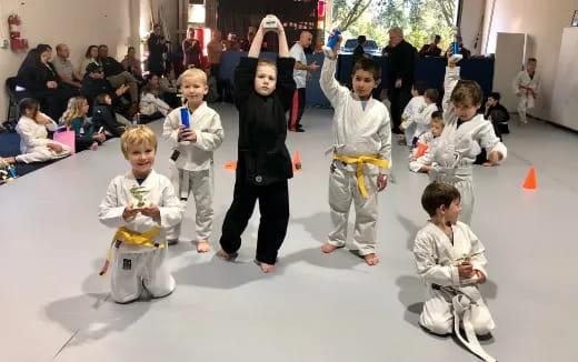 a group of children in karate uniforms