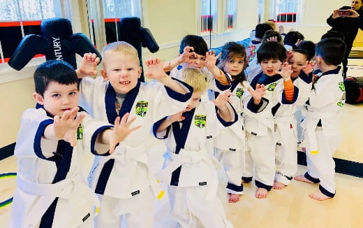 a group of children in karate uniforms