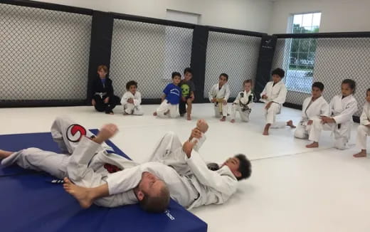 a group of people in white karate uniforms