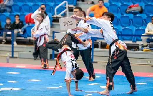 a group of people in karate uniforms