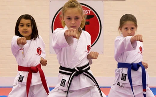 a group of girls in karate uniforms