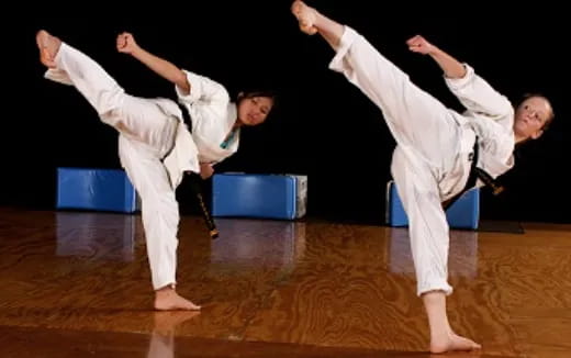 a group of people in karate uniforms