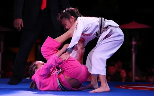 a man and a woman in karate uniforms on a mat