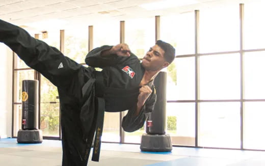 a person in uniform leaning on a machine