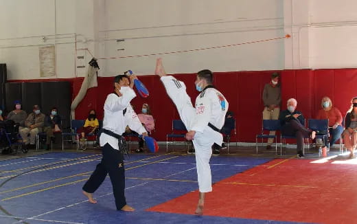 a couple of people in karate uniforms
