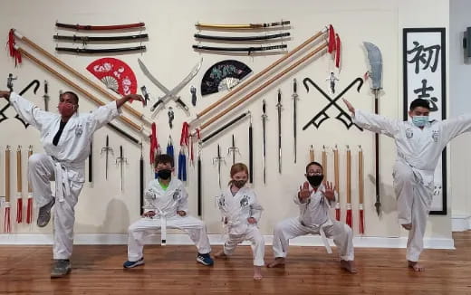 a group of people in white suits