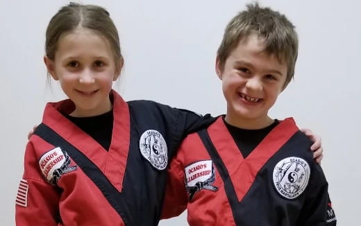 two boys wearing football uniforms