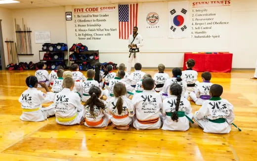 a group of children sitting on the floor in a room
