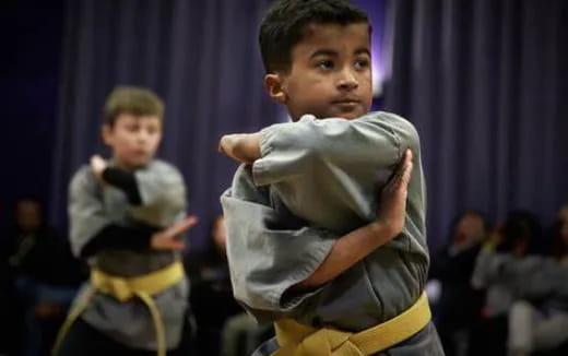 a boy in a karate uniform