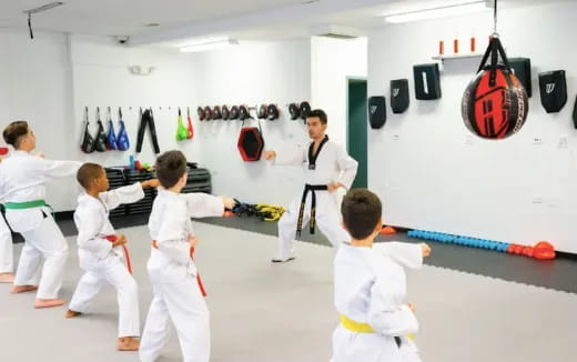 a group of kids in karate uniforms