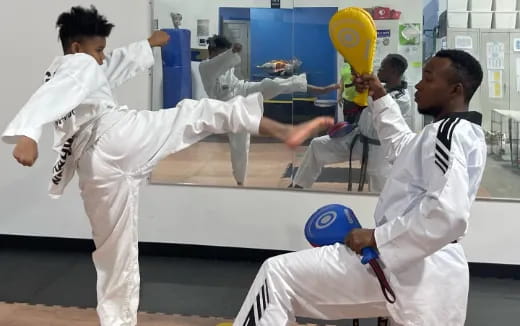 a group of people in white karate uniforms