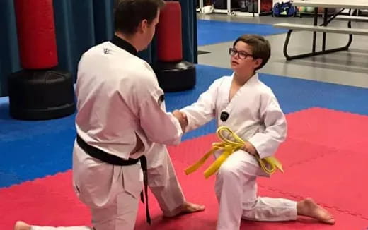 a man and a woman in karate uniforms