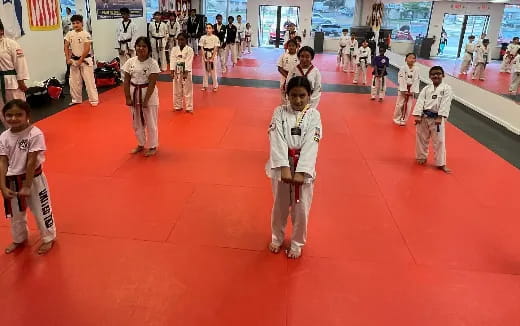 a group of children in karate uniforms