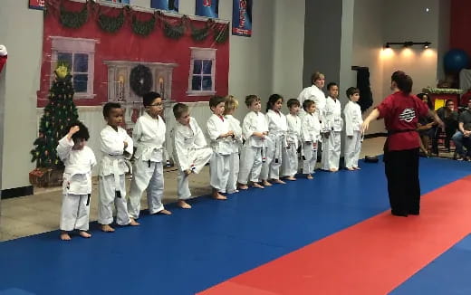 a group of children in karate uniforms