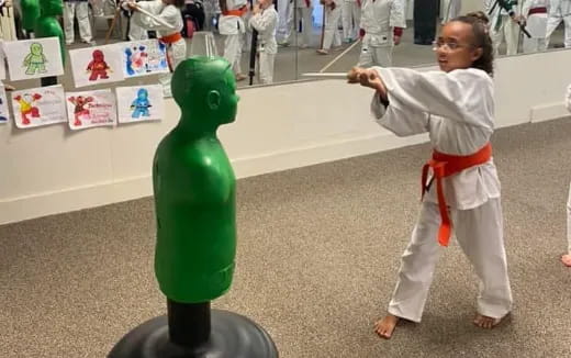 a child touching a statue