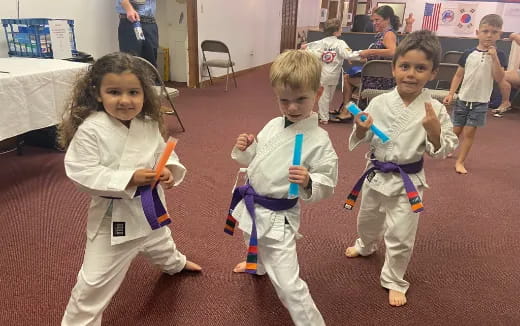 a group of children in karate uniforms
