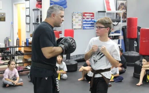 a person holding a child in a gym