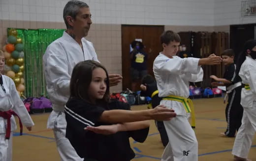 a group of people in karate uniforms