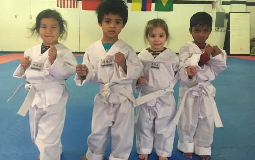 a group of kids in karate uniforms