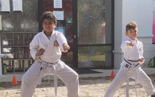 two boys in karate uniforms