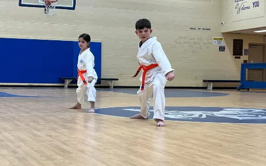 a couple of boys in karate uniforms