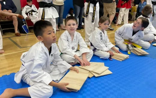 a group of children in white uniforms