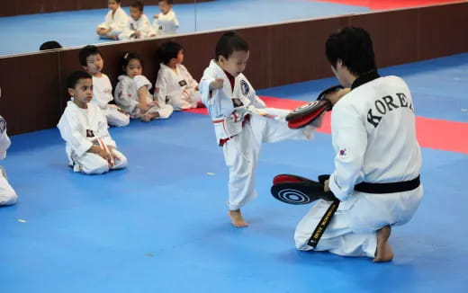 a group of kids in karate uniforms