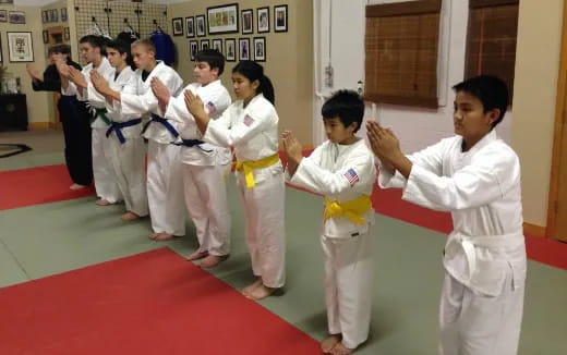a group of kids in karate uniforms