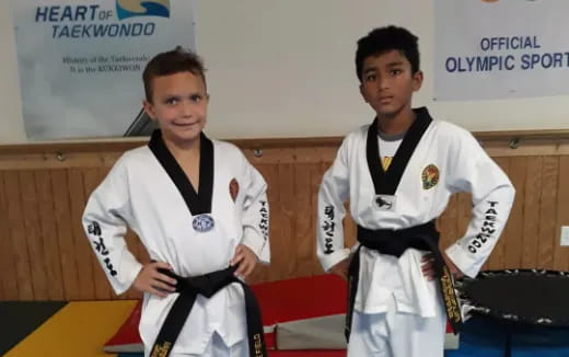 a couple of boys in karate uniforms