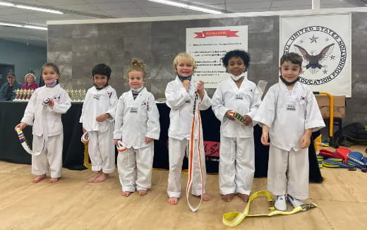 a group of kids in karate uniforms