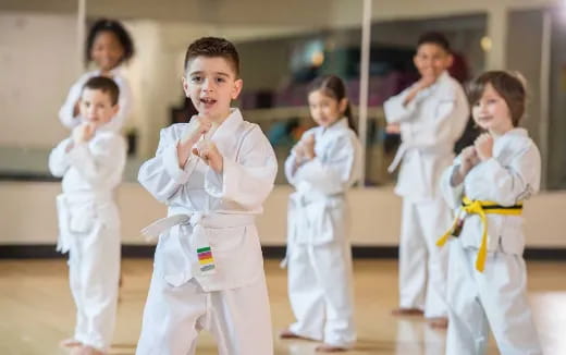 a group of children in karate uniforms