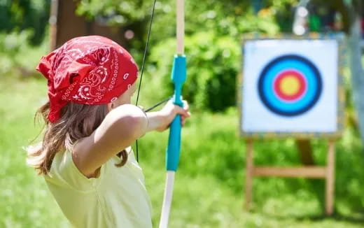 a girl holding a bow and arrow