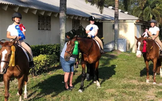 a group of people riding horses