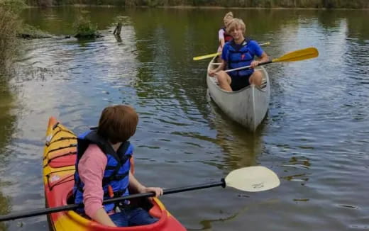 a group of people in kayaks on a river