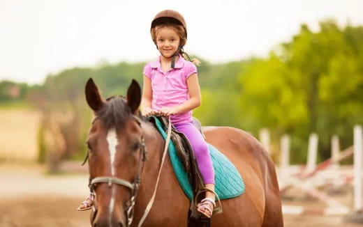 a girl riding a horse