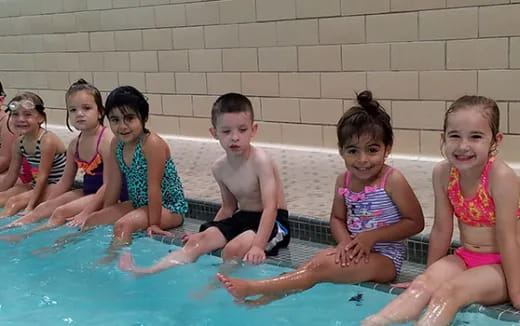 a group of children in a pool