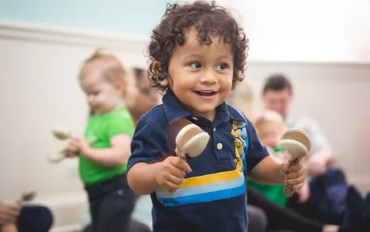 a young boy holding a ball