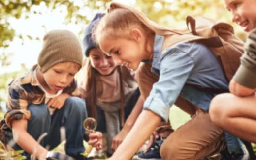 a group of children sitting outside