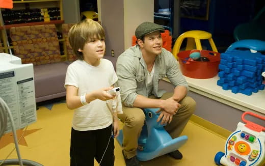 a person and a girl playing video games