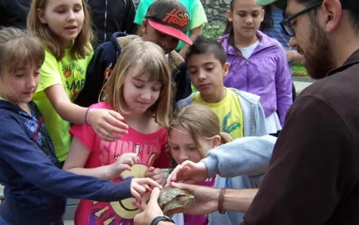 a group of people holding a snake