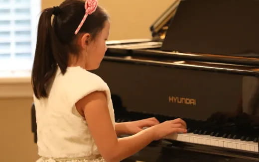 a girl playing a piano