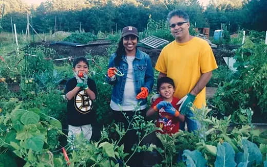 a group of people posing for a photo in a garden